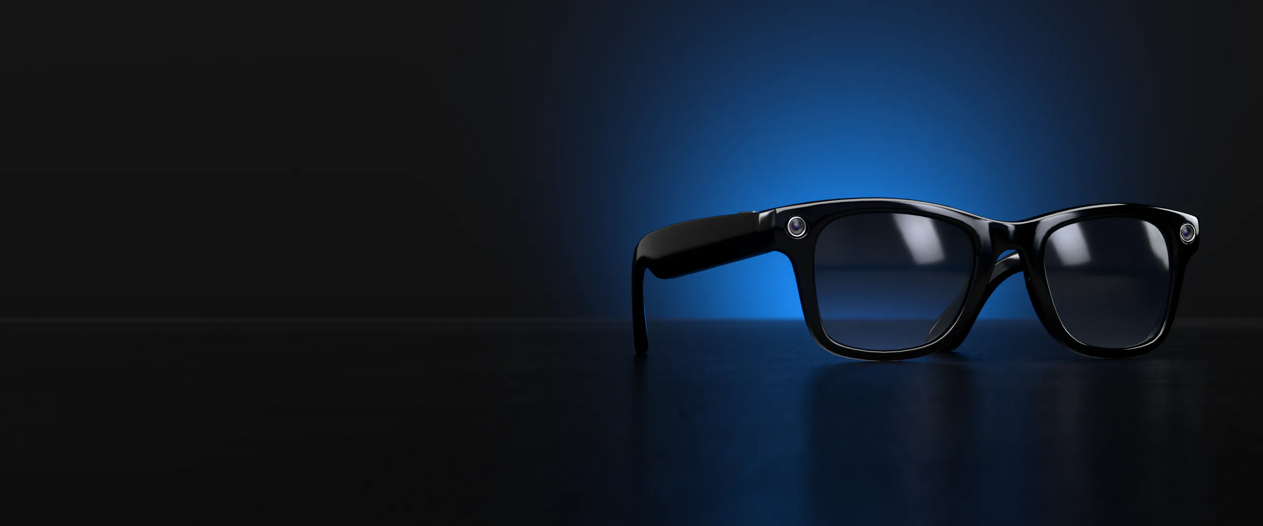 Ray-Ban Meta smart glasses on a floor, lit blue from behind